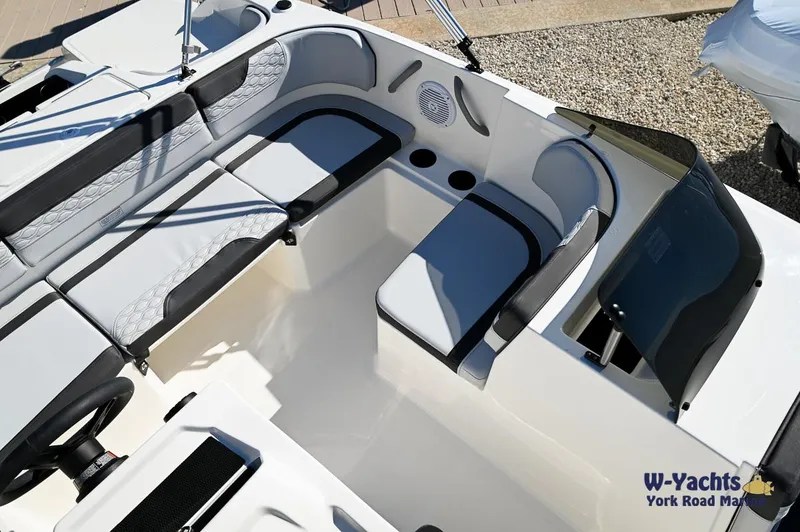 Slide: The Image of 2024 Bayliner M17 boat interior with cushioned seating and storage compartments. - 11