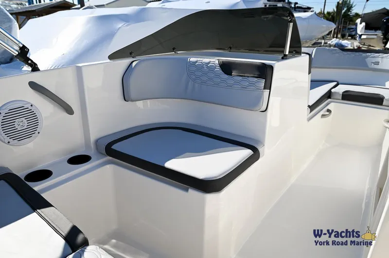 Slide: The Image of 2024 Bayliner M17 boat interior with cushioned seating and cup holders. - 13