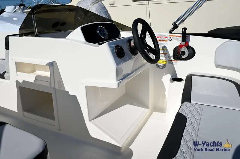Slide: The Image of 2024 Bayliner M17 boat cockpit with steering wheel and control panel. - 16