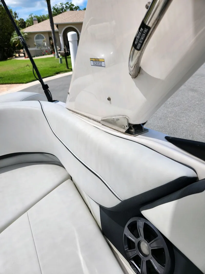 Slide: The Image of 2021 Regal 23 OBX boat interior with white leather seating and speaker. - 3