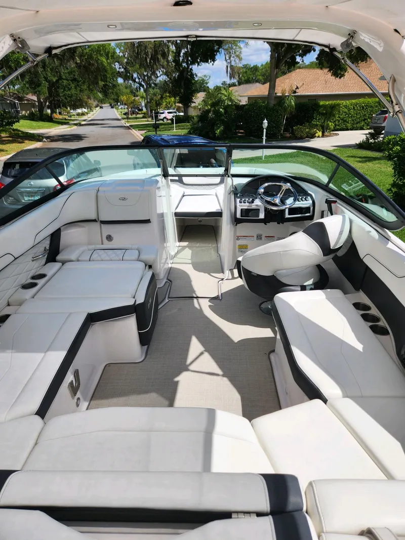 Slide: The Image of 2021 Regal 23 OBX boat interior with white seating and modern dashboard. - 7