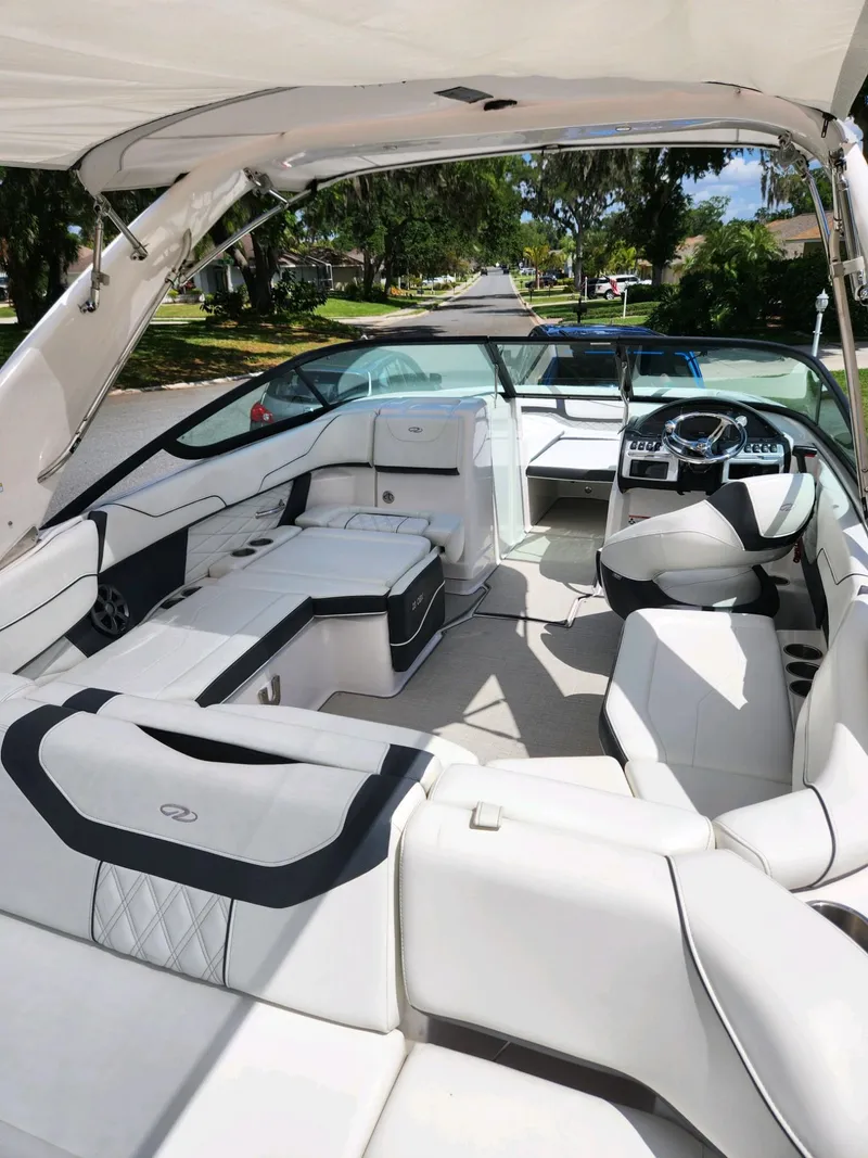 Slide: The Image of 2021 Regal 23 OBX boat interior with white seating and modern dashboard. - 8