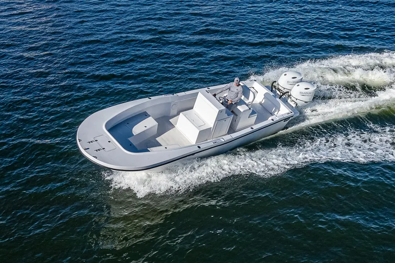 The Image of 2023 Dusky 27cc boat cruising on open water, showcasing sleek design and powerful engines. - 1