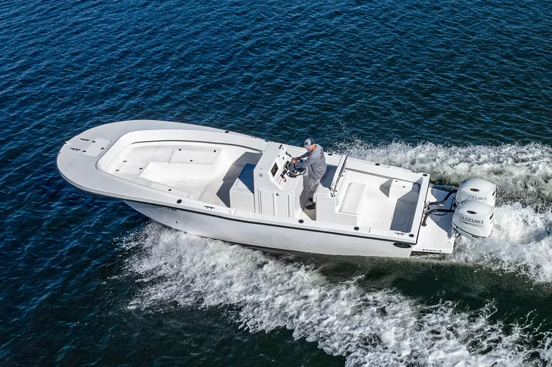 Slide: The Image of 2023 Dusky 27cc boat cruising on open water with dual engines. - 3