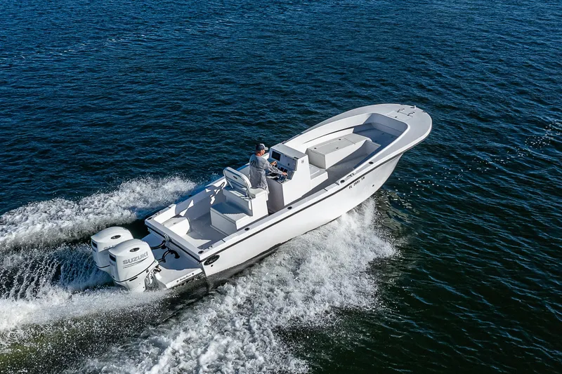 Slide: The Image of 2023 Dusky 27cc boat cruising on open water, showcasing sleek design and powerful engines. - 4