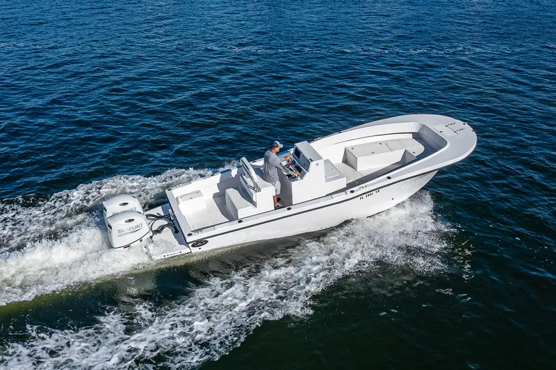 Slide: The Image of 2023 Dusky 27cc boat cruising on open water with dual engines. - 5