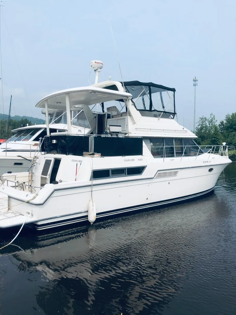 The Image of 1994 Carver 430 Cockpit Motor Yacht docked on calm water. - 0