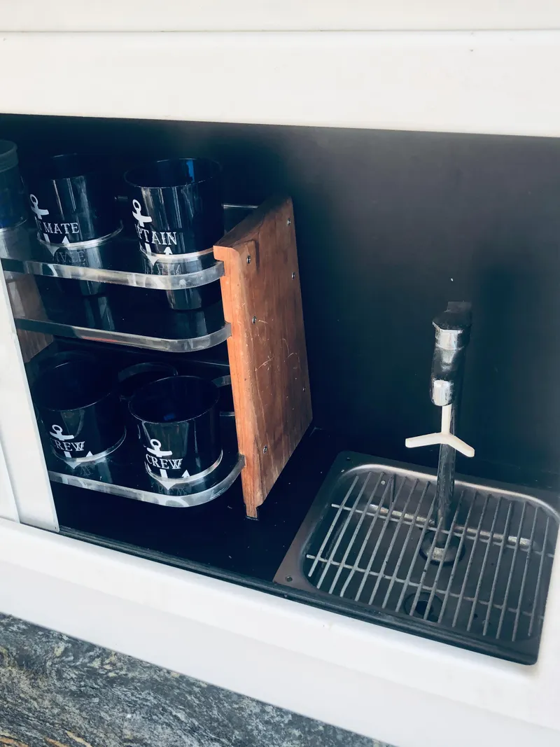 Slide: The Image of Cup holder and tap on 1994 Carver 430 Cockpit Motor Yacht. - 11