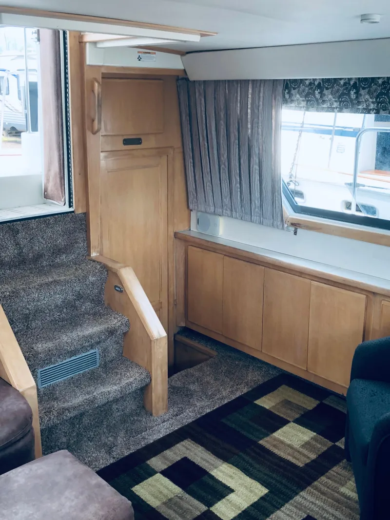 Slide: The Image of Interior of 1994 Carver 430 Cockpit Motor Yacht with carpeted stairs and wooden cabinetry. - 7