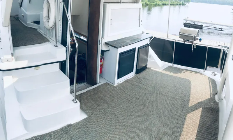 Slide: The Image of 1994 Carver 430 Cockpit Motor Yacht interior with carpeted deck and outdoor grill. - 5