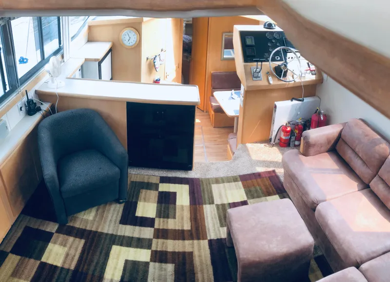 Slide: The Image of Interior of 1994 Carver 430 Cockpit Motor Yacht with seating, helm, and patterned carpet. - 8