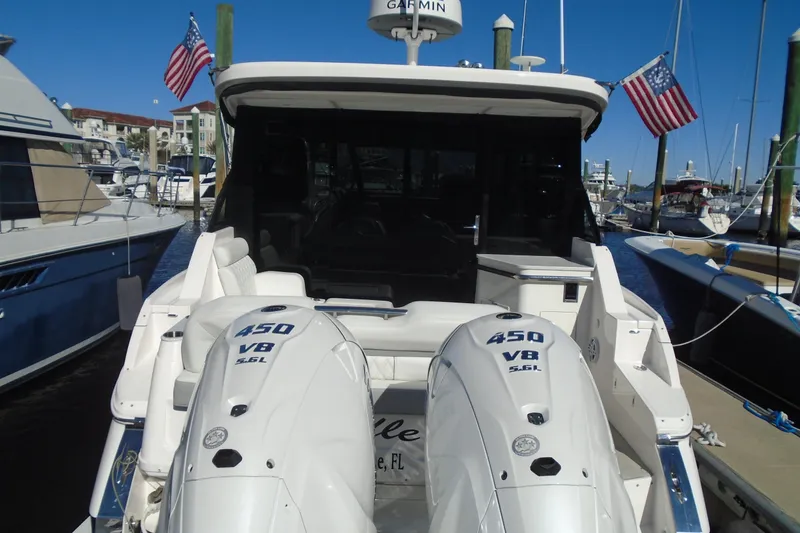 Slide: The Image of 2024 Regal 36 XO boat with twin 450 V8 engines docked at marina. - 1