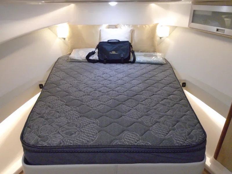 Slide: The Image of Luxurious bed in Regal 36 XO 2024 yacht interior. - 19