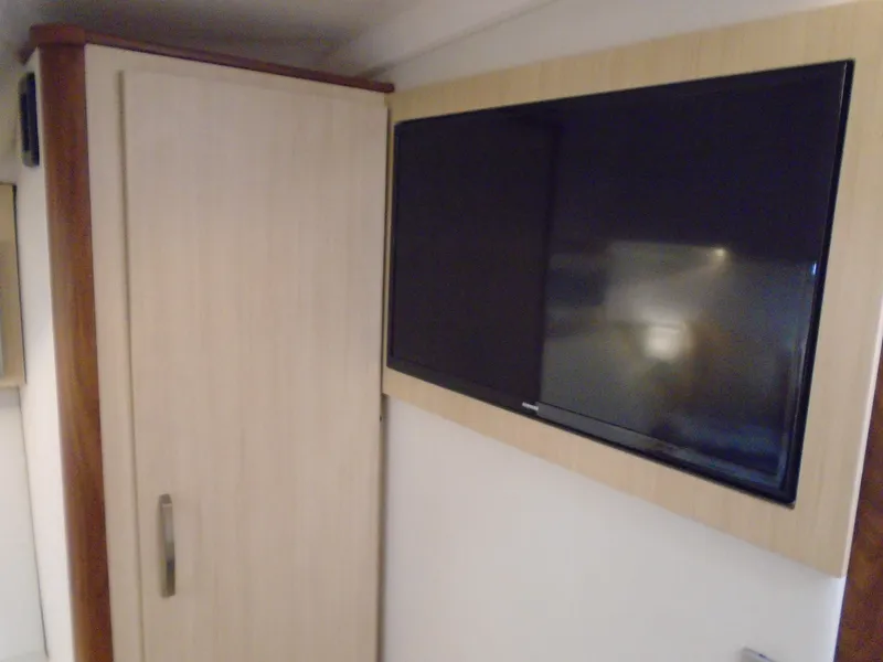 Slide: The Image of Interior of 2024 Regal 36 XO with cabinet and TV. - 26