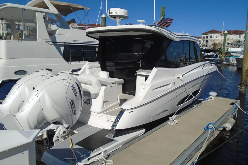 Slide: The Image of 2024 Regal 36 XO luxury yacht docked with twin Yamaha engines. - 3