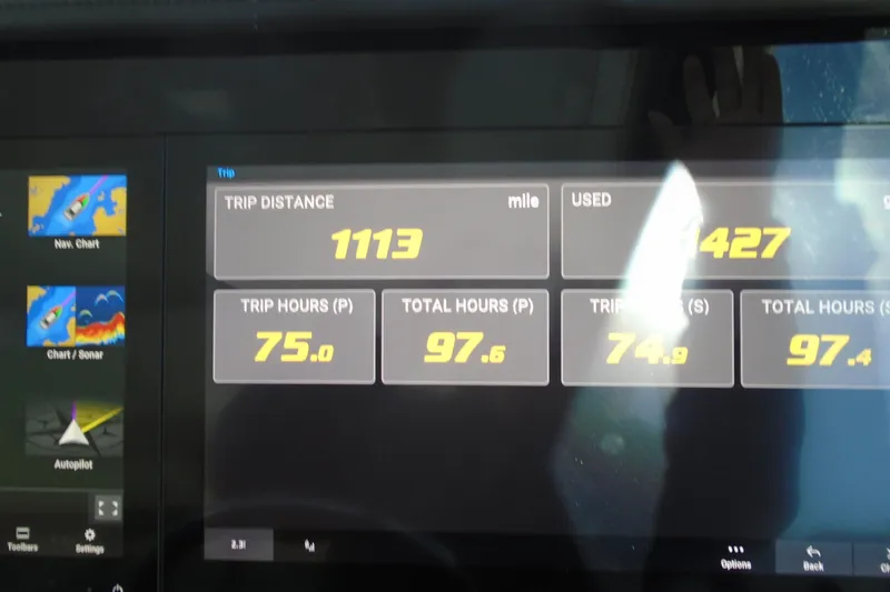 Slide: The Image of 2024 Regal 36 XO dashboard displaying trip distance and engine hours. - 34