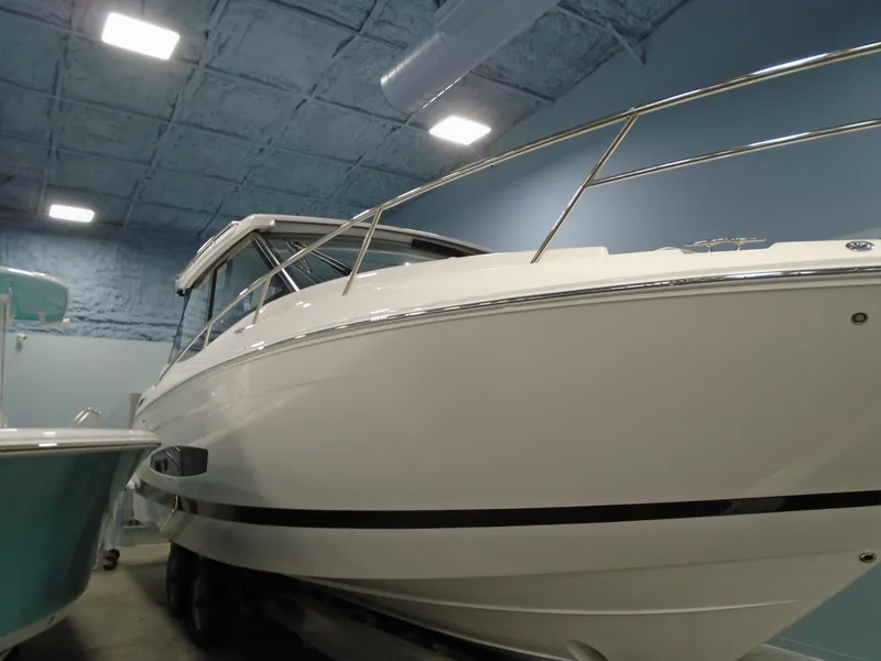 Slide: The Image of 2024 Regal 36 XO boat displayed indoors. - 4