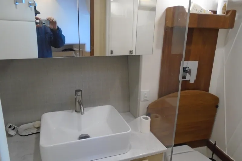 Slide: The Image of 2024 Regal 36 XO bathroom with modern sink, mirror, and wooden accents. - 42
