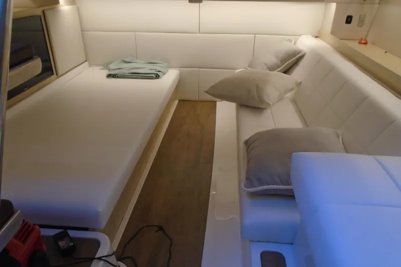Slide: The Image of Luxurious interior of 2024 Regal 36 XO yacht with white seating and cushions. - 43