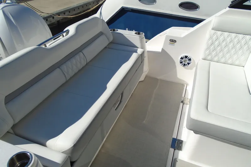 Slide: The Image of 2024 Regal 36 XO boat interior with luxurious white seating and cup holders. - 44