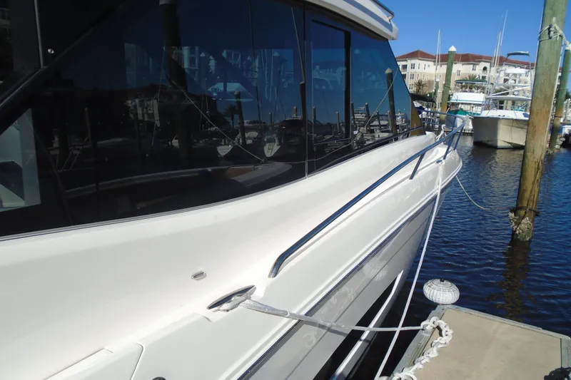 Slide: The Image of 2024 Regal 36 XO yacht docked at marina, showcasing sleek design and modern features. - 46