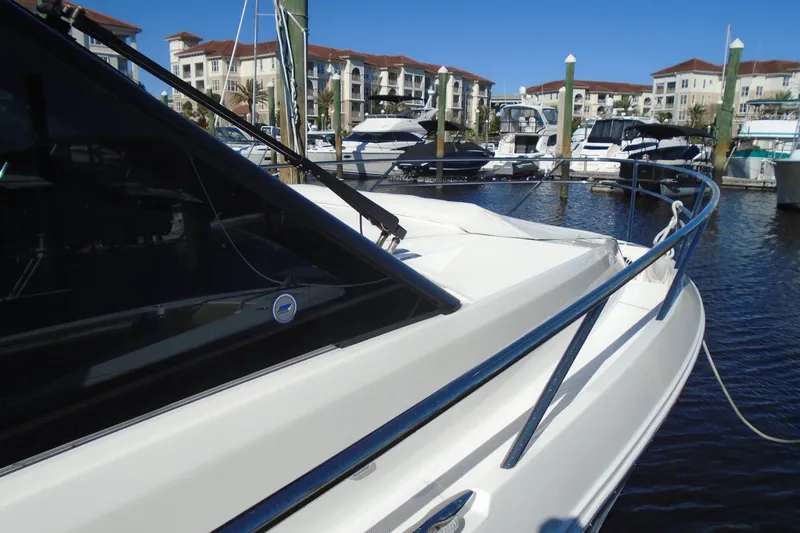 Slide: The Image of 2024 Regal 36 XO yacht docked at marina with waterfront buildings. - 47