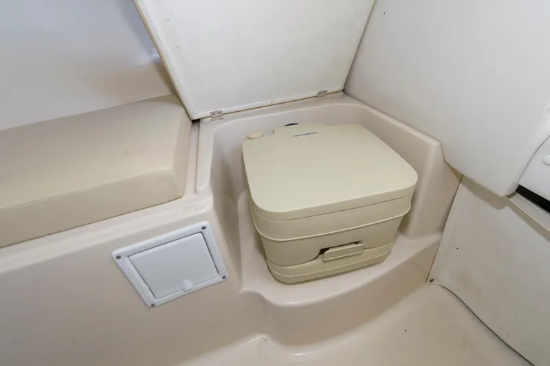 Slide: The Image of 2016 Wellcraft 232 Coastal boat interior with portable toilet. - 11