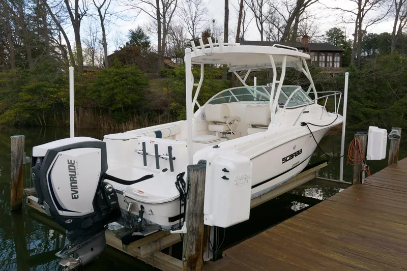 Slide: The Image of 2016 Wellcraft 232 Coastal boat docked with Evinrude outboard motor. - 3