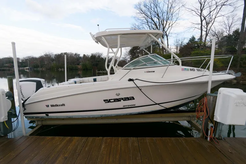 Slide: The Image of 2016 Wellcraft 232 Coastal boat docked on a calm lake. - 4