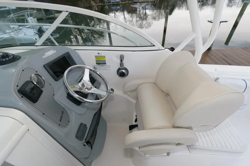 Slide: The Image of Helm station of 2016 Wellcraft 232 Coastal boat with steering wheel and captain's chair. - 6