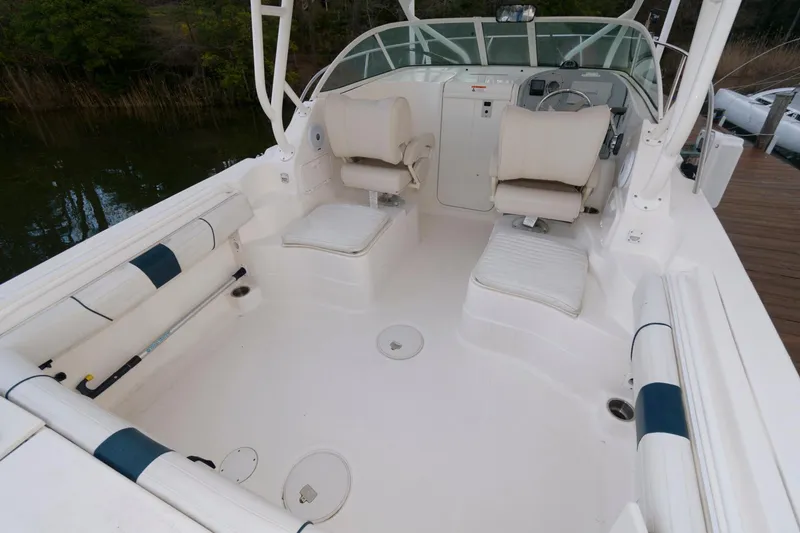 Slide: The Image of 2016 Wellcraft 232 Coastal boat interior with seating and helm station. - 7
