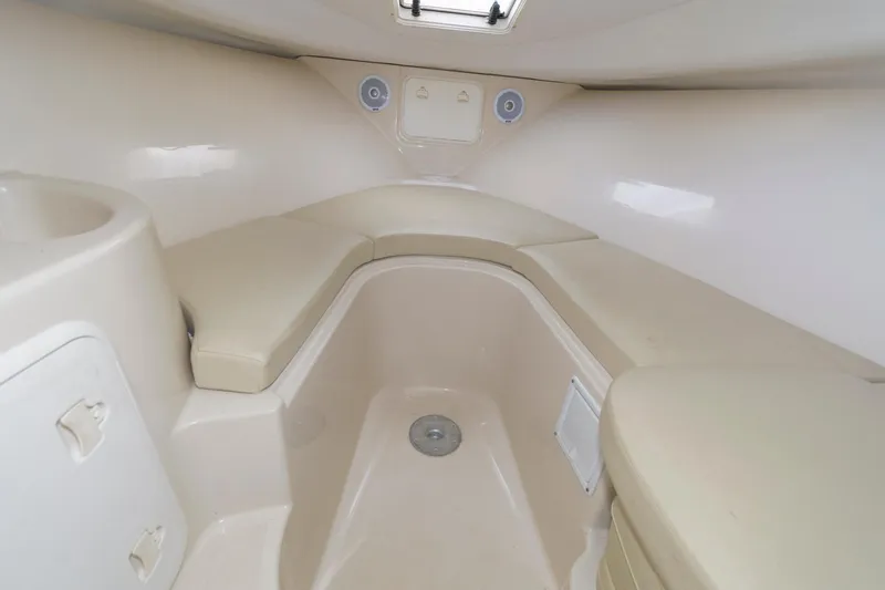 Slide: The Image of Interior cabin of 2016 Wellcraft 232 Coastal boat with beige seating and storage. - 9