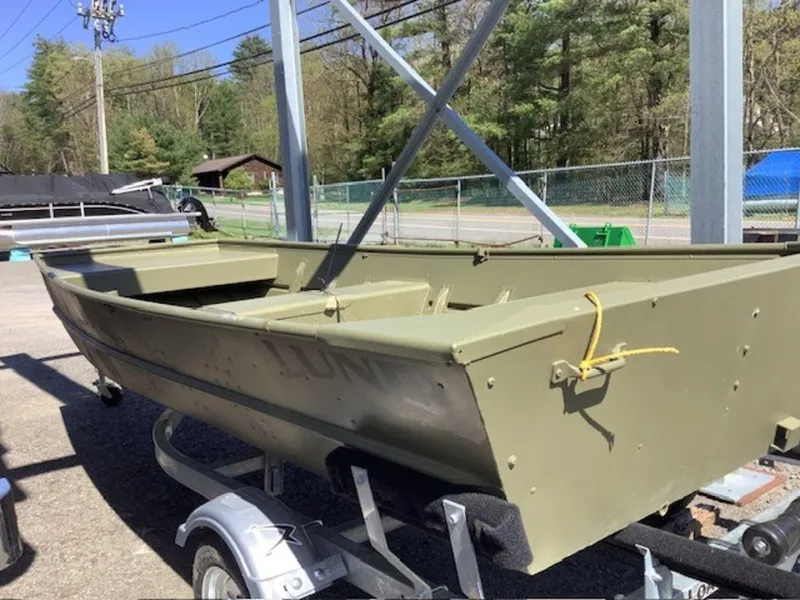Slide: The Image of 2024 Lund 1448 boat in marshland with a person and fishing gear. - 3