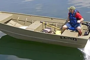 Slide: The Image of 2024 Lund 1448 boat with person on a lake, surrounded by lush greenery. - 8