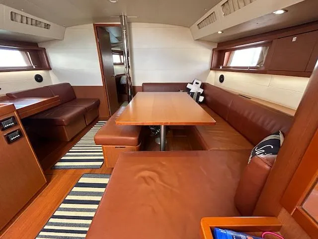 Slide: The Image of Interior of 2013 Beneteau 48 sailboat with wooden stairs and modern design. - 12