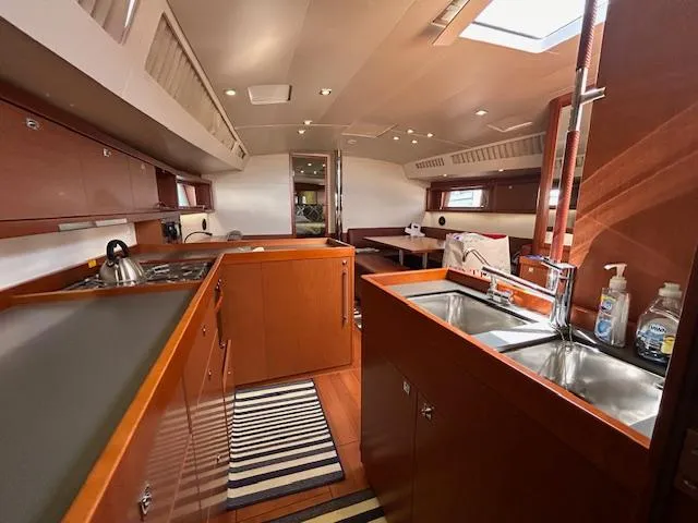 Slide: The Image of Interior of 2013 Beneteau 48 sailboat with kitchen and sleeping area. - 15