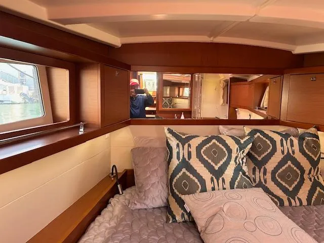 Slide: The Image of Luxurious bedroom interior of 2013 Beneteau 48 yacht with wooden cabinetry and cozy bedding. - 21