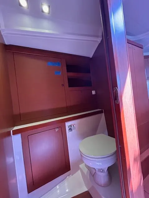 Slide: The Image of Interior cabin of 2013 Beneteau 48 yacht with cozy bedding and decorative pillows. - 23