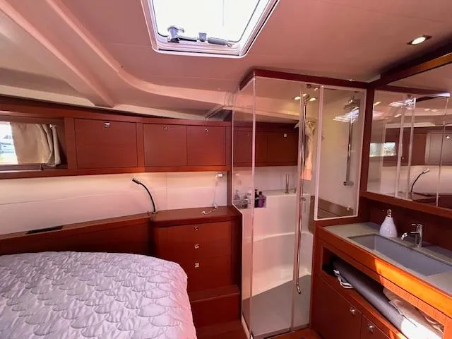 Slide: The Image of 2013 Beneteau 48 yacht bathroom with wooden cabinets and modern fixtures. - 25