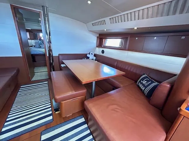 Slide: The Image of Interior cabin of a 2013 Beneteau 48 sailboat with a bed and window. - 37