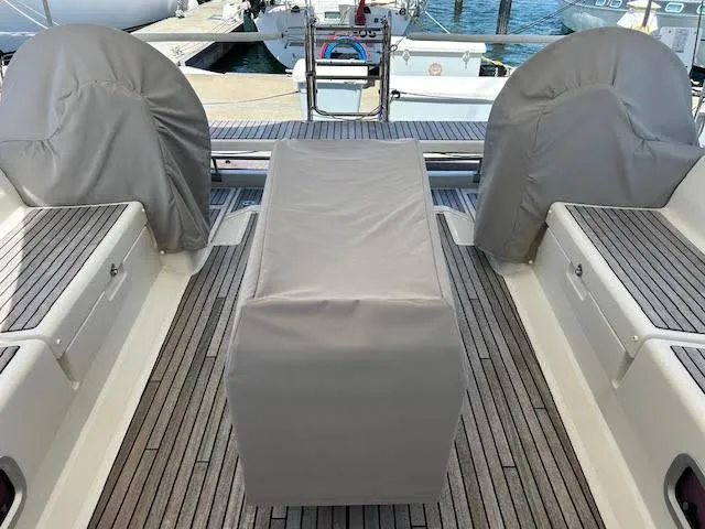 Slide: The Image of Beneteau 48 (2013) yacht docked at marina with wooden deck and stainless steel ladder. - 42