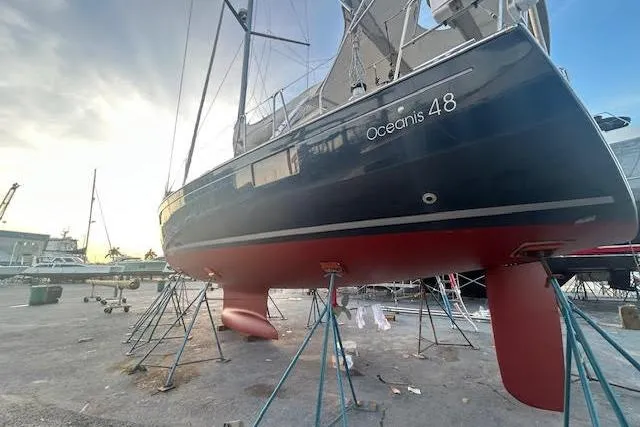 Slide: The Image of 2013 Beneteau Oceanis 48 sailboat on stands, showcasing sleek design and craftsmanship. - 47