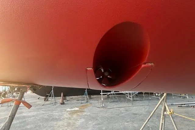 Slide: The Image of Red hull of 2013 Beneteau Oceanis 48 sailboat with visible bow thruster. - 51