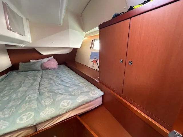 Slide: The Image of Beneteau 48 sailboat cockpit, 2013 model, docked at marina with wooden table and seating. - 9