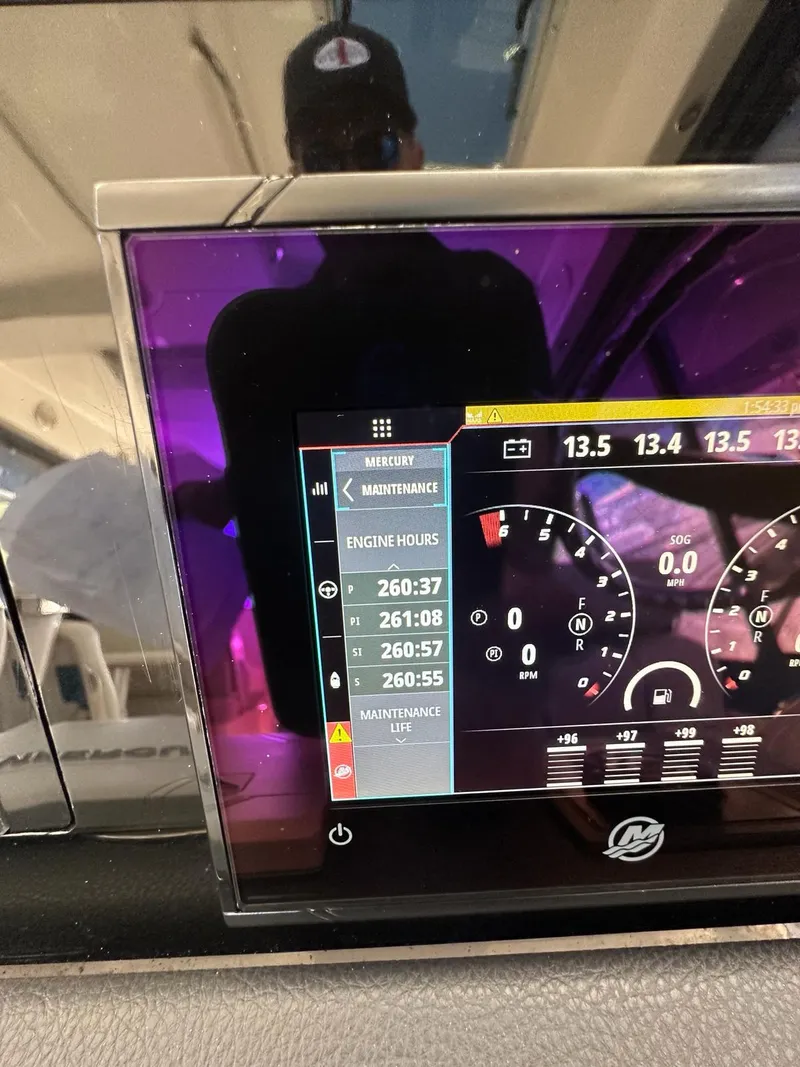 Slide: The Image of Dashboard of a 2021 Boston Whaler 405 Conquest showing engine hours and gauges. - 12