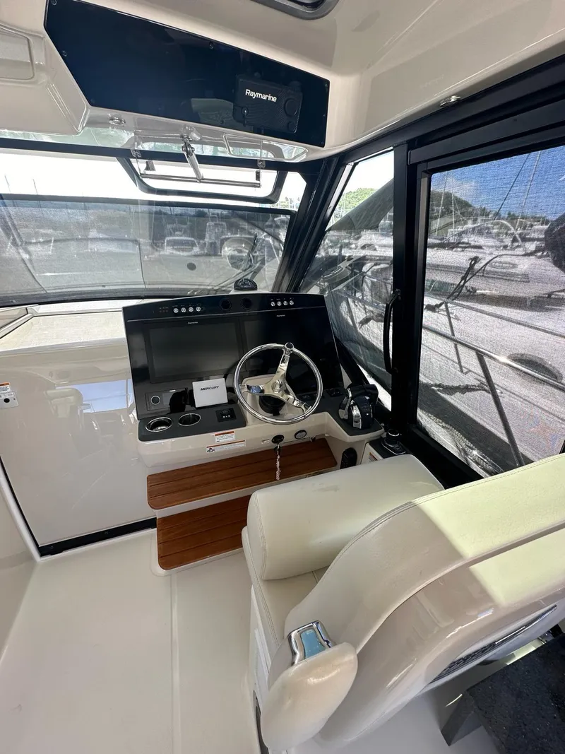 Slide: The Image of Interior helm of 2021 Boston Whaler 405 Conquest with modern controls and seating. - 5