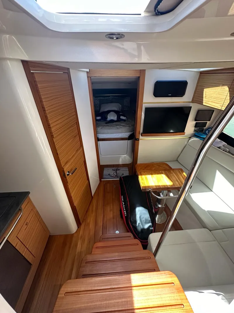 Slide: The Image of Interior of 2021 Boston Whaler 405 Conquest, featuring wood accents and modern furnishings. - 6