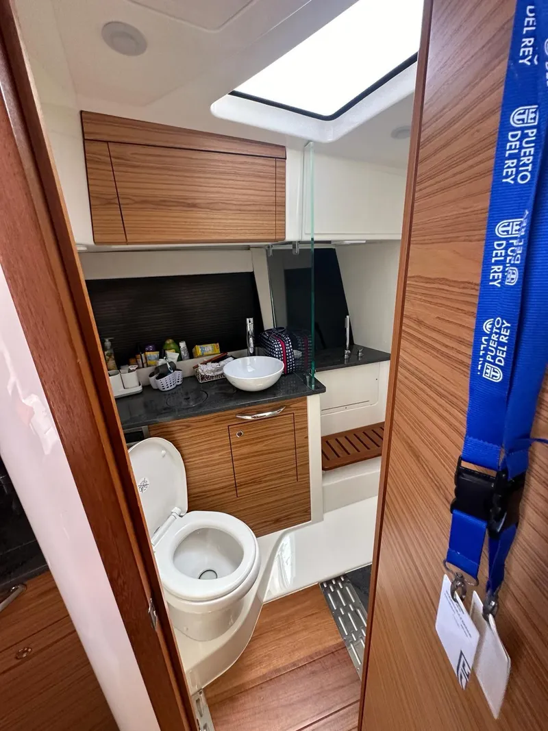 Slide: The Image of 2021 Boston Whaler 405 Conquest bathroom with modern wood cabinetry and sleek fixtures. - 8