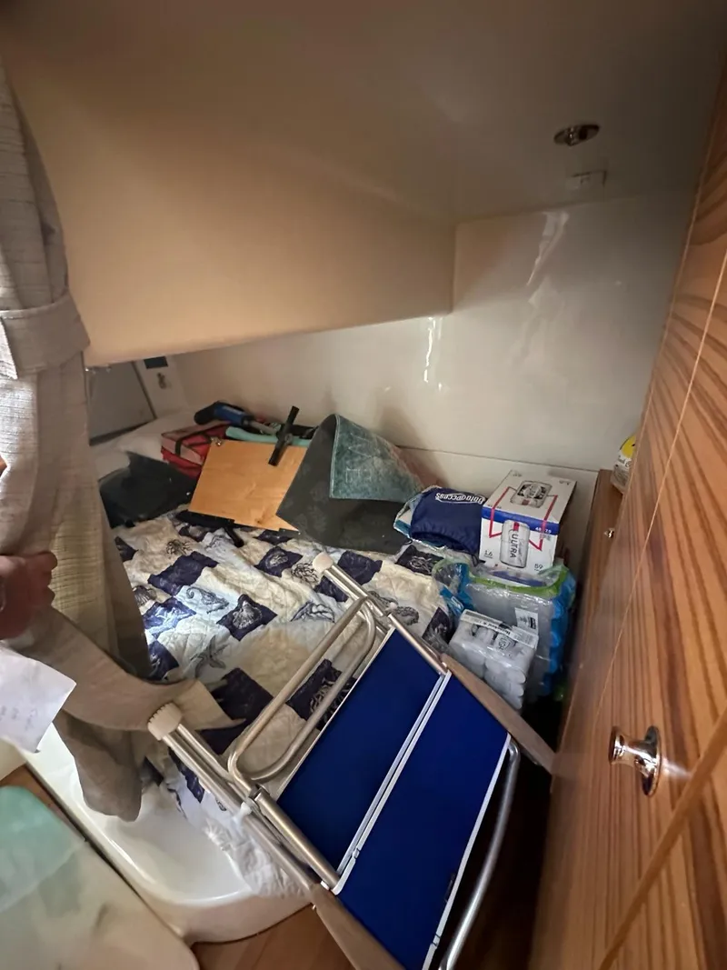 Slide: The Image of Interior cabin of 2021 Boston Whaler 405 Conquest with bed and stored items. - 9