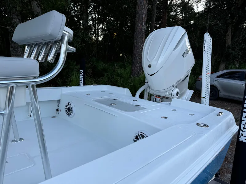 Slide: The Image of 2024 Contender 23 Bay boat with Yamaha outboard motor in wooded setting. - 10